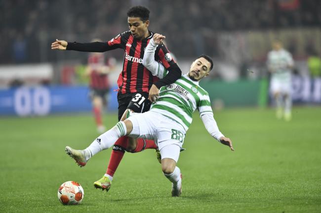 Celtic left back Josip Juranovic, right, tackles Amine Adli of Bayer Leverkusen in Germany