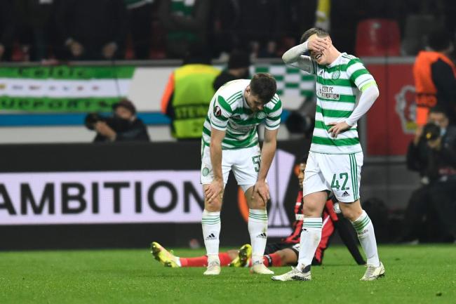 Celtic captain Callum McGregor holds his head after defeat to Bayer Leverkusen in Germany tonight