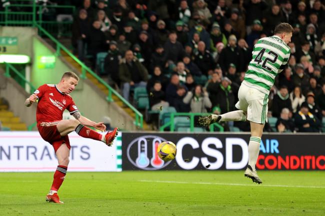 Celtic captain Callum McGregor, right, sends a clearance by Jonny Hayes into the Aberdeen net