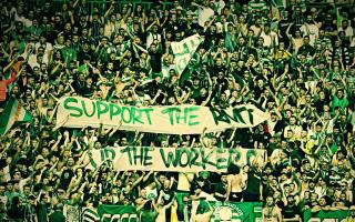 Celtic fans hold aloft a banner in support of the RMT earlier this season